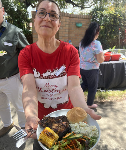 woman holding a plate of freshly prepared food