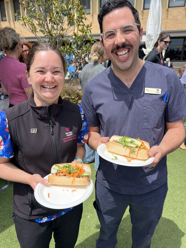 Happy corporate customers enjoying Flying Woks Banh Mi rolls at their event