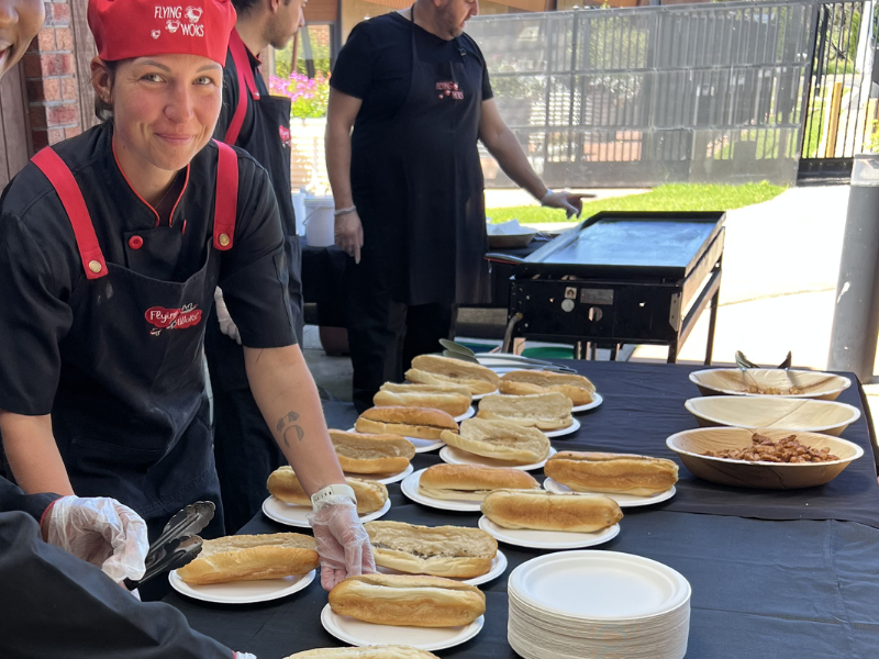 Flying Woks chef preparing fresh Bánh Mì rolls at a live catering station Melbourne