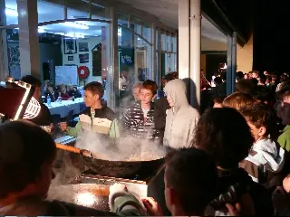 Crowd gathered around Flying Woks giant wok at a birthday celebration