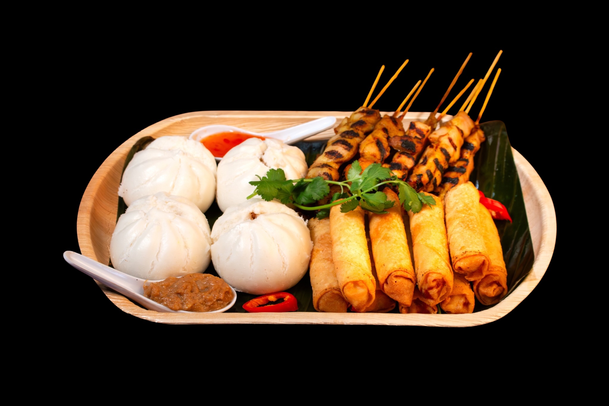 Flying Woks premium finger food platter with bao buns, spring rolls and satay on natural palm leaf tray