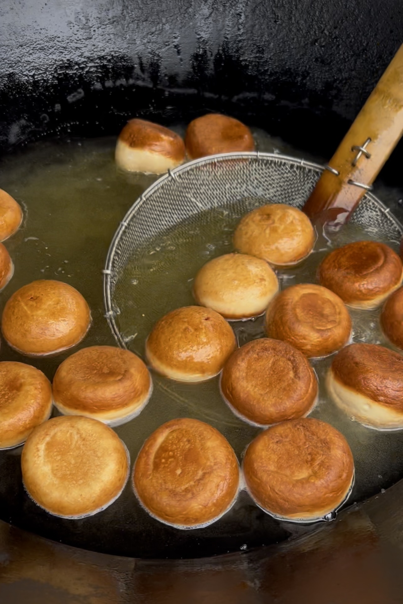 Jam doughnuts frying live in a wok at a Flying Woks event