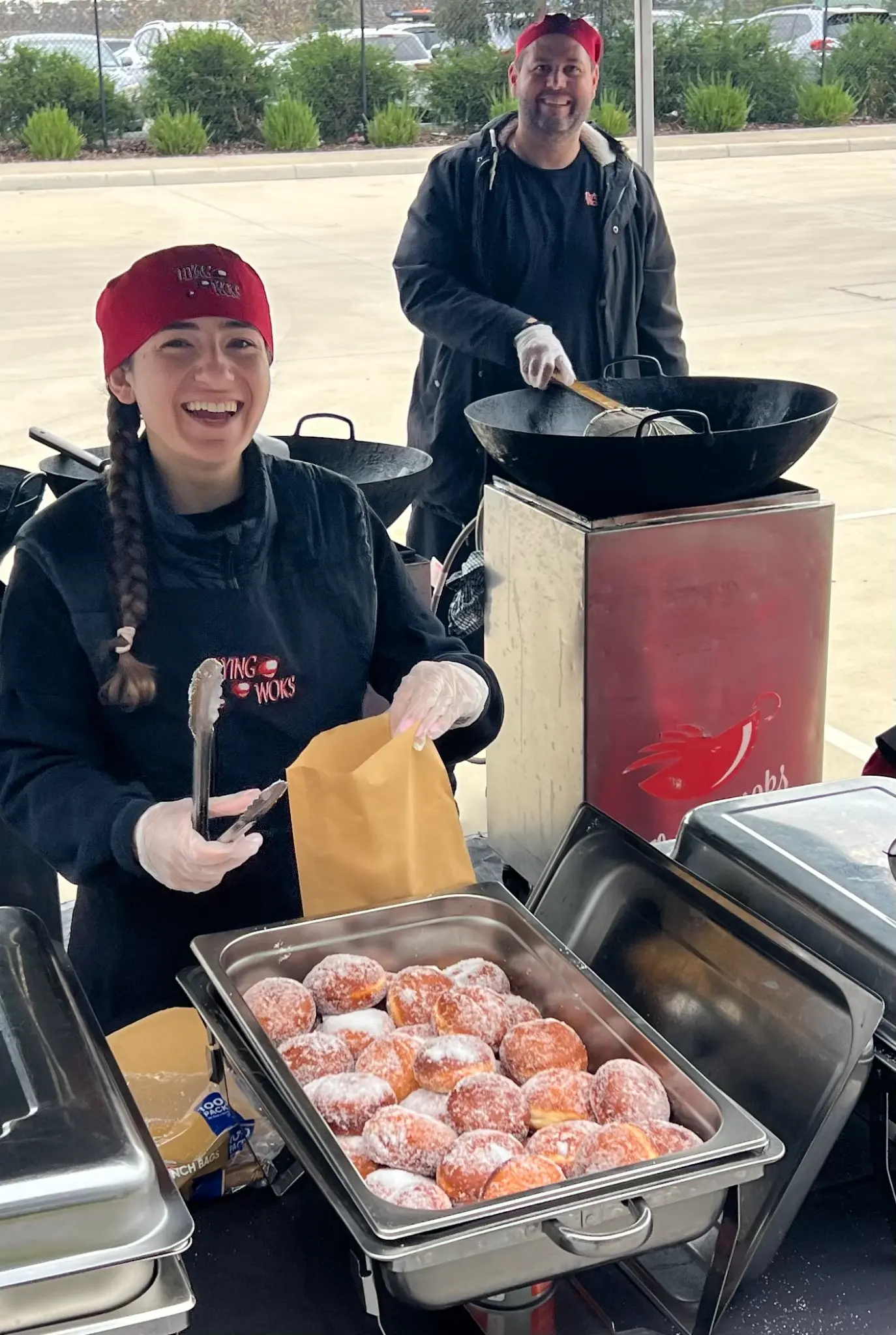 Flying Woks team serving fresh hot jam doughnuts live at a Melbourne corporate event