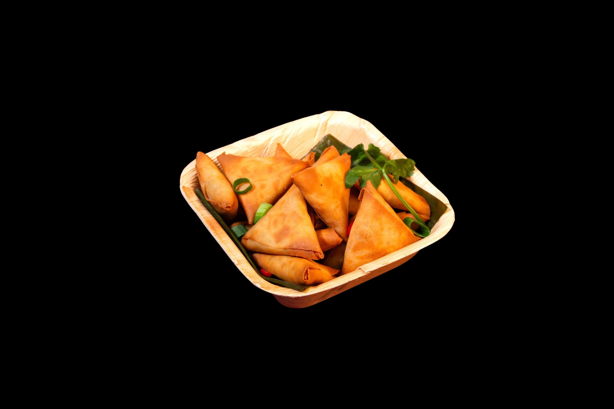 Flying Woks crispy samosas in natural palm leaf plate — eco-friendly premium serveware