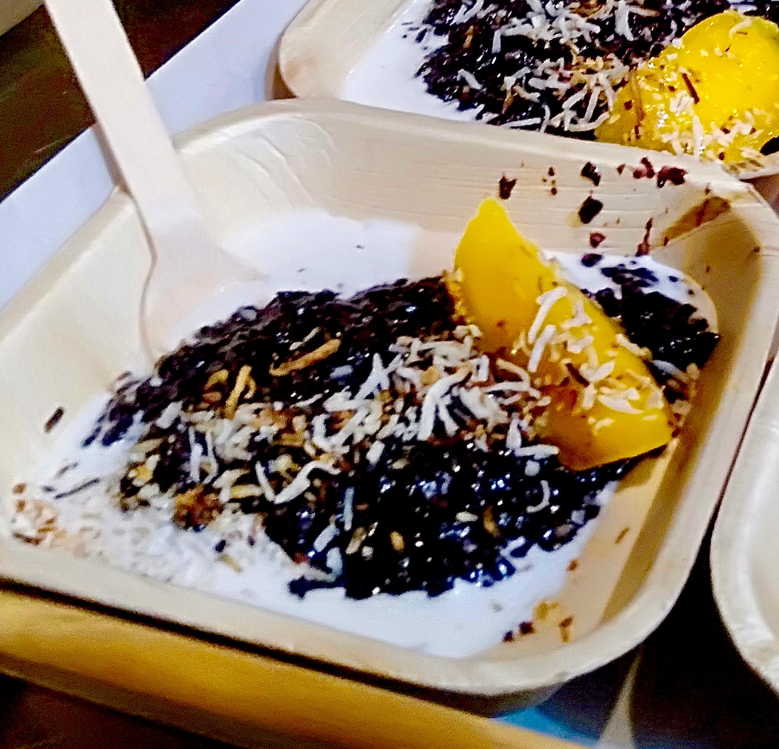 Black rice pudding with mango, coconut and sesame