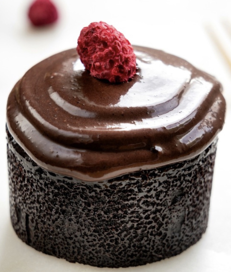 Rich chocolate ganache dessert topped with raspberry
